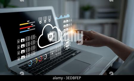 Engaging digital security concept showcasing cloud technology and data protection icons displayed on a laptop screen, emphasizing user interaction and Stock Photo
