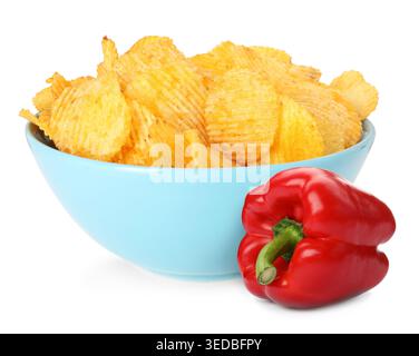 Paprika-flavored potato chips in bowl and fresh bell pepper isolated on white Stock Photo