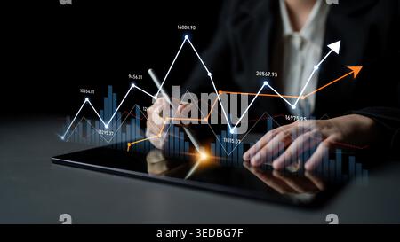 A business professional engages with a tablet, analyzing financial data trends illustrated by dynamic graphs and charts, representing modern Stock Photo