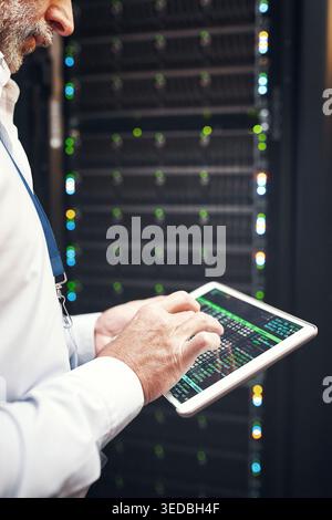 Hands, man or code on tablet screen in server room for CPU usage, track assets or IT support. Technician, mature person or tech in data center for Stock Photo