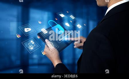 A businessman interacts with a digital tablet to manage online security, illustrated by icons representing cybersecurity and user authentication in a Stock Photo