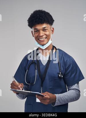 Clipboard, man and nurse in studio for healthcare career, about us and writing on white background. Checklist, medical support and person with smile Stock Photo