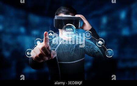 A young man engages with an immersive virtual reality experience, showcasing data-driven insights that enhance online business strategies and Stock Photo