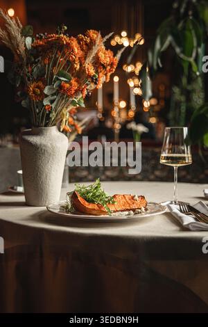 Baked pumpkin served on elegant restaurant table Stock Photo