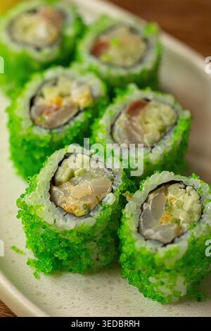 Sushi rolls with green coating and ginger Stock Photo