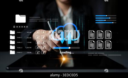 A business professional interacts with a digital tablet, illustrating file upload and cloud computing through icons. The image embodies modern data Stock Photo