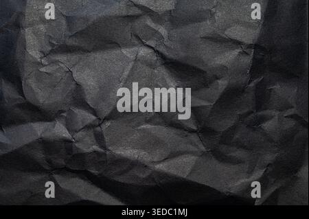 Crumpled sheets of paper, with natural creases and shadows that create an organic and versatile texture. Stock Photo
