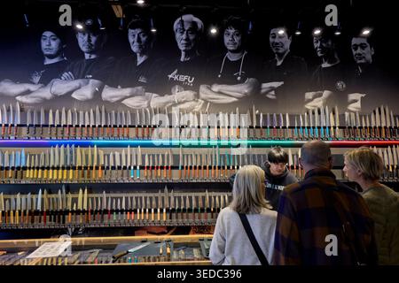 Customers buying Japanese kitchen knives in a specialized knife shop at Kappabashi street in Asakusa, Tokyo, Japan. Stock Photo