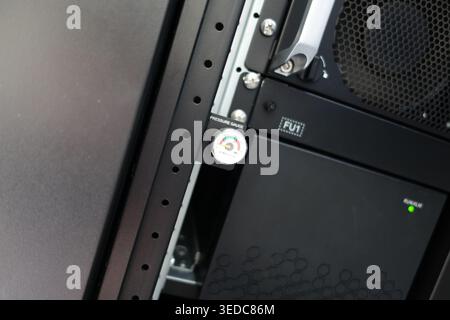 Close-up view of a pressure gauge mounted in a server rack, showcasing technology and infrastructure used for monitoring equipment performance and saf Stock Photo