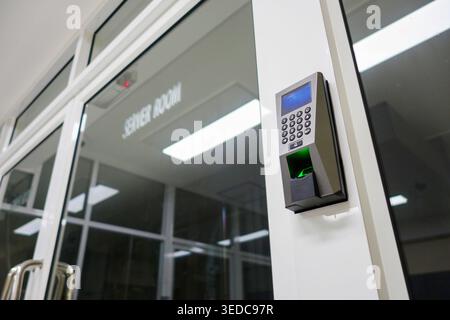 A modern access control system featuring a keypad and scanner on an entrance door, highlighting security technology in contemporary architectural desi Stock Photo