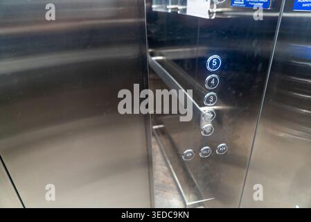 Close-up of modern elevator control panel featuring stainless steel finish and illuminated floor buttons. Ideal for showcasing technology and accessib Stock Photo