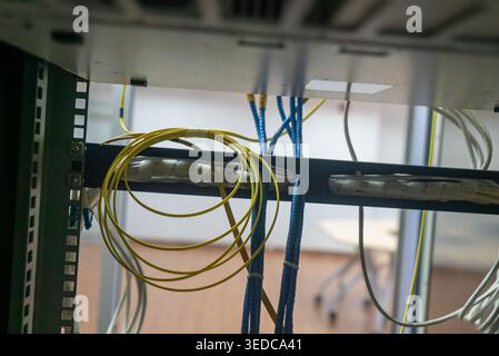Detailed view showing networking cables organized in a rack. This image highlights technology infrastructure essential for data connectivity in modern Stock Photo