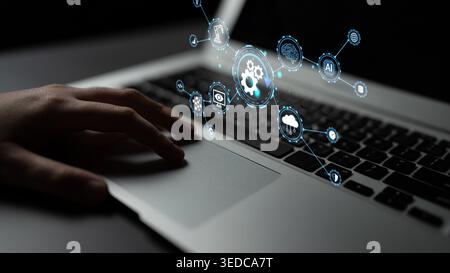 Modern Technology Concept Showing Hand Interacting with Digital Interface and Icons on Laptop in Dark Environment Focused on Innovation and Stock Photo