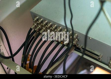 Close-up view of various cables and connectors highlighting intricate details of the wiring system in electronic equipment and machinery setups. Stock Photo