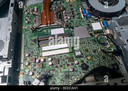 Close-up view of a computer circuit board showcasing various electronic components and connections, illustrating the intricate design of modern techno Stock Photo