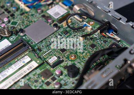 Close-up view of a computer circuit board showcasing intricate components, wiring, and connections, illustrating technology and engineering in modern Stock Photo