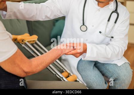 Close up of doctor holding hand of a orthopedic patient. Stock Photo