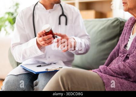 Close up of doctor holding pill box and explaining therapy to a patient. Stock Photo