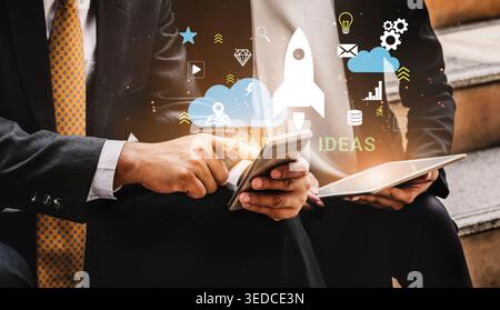 Business professionals discussing innovative ideas with digital technology in a modern workspace environment featuring various creative icons Haptic. Stock Photo