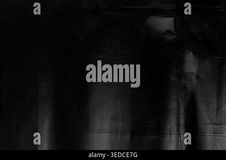 Abstract black grunge texture with crumpled paper effect, dots and aged defects. High-contrast dark background with creases and scratches Stock Photo