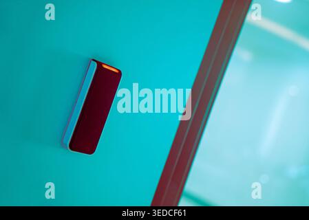 A sleek modern smart door lock device mounted on a vibrant wall, blending technology with contemporary design for enhanced home security and convenien Stock Photo