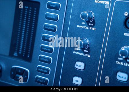 Close-up view of an audio mixer control panel showcasing various buttons and knobs for sound adjustments, essential for music production in profession Stock Photo