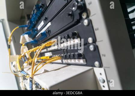 Close-up of fiber optic network equipment showcasing cables and connectors. This image represents the technology used for high-speed data transfer and Stock Photo