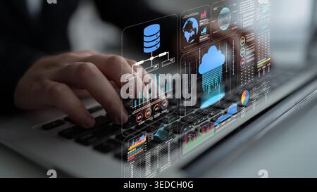 Hands of a business professional interacting with futuristic data analytics and cloud technology graphics on a digital screen while using a laptop Stock Photo