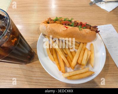 Banh mi sandwich, Vietnamese baguette filled with savory meats, fresh herbs, and pickled vegetables, fries. Heineken Bar & Kitchen, Phu Quoc airport Stock Photo