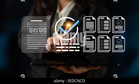 A business professional engages with a digital tablet to verify documents, showcasing workflow icons and checkmarks in a sleek office setting for Stock Photo