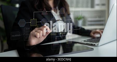 Businesswoman Analyzing Digital Workflow with Magnifying Glass in Modern Office, Project Planning and Management Concept, Technology and Innovation in Stock Photo