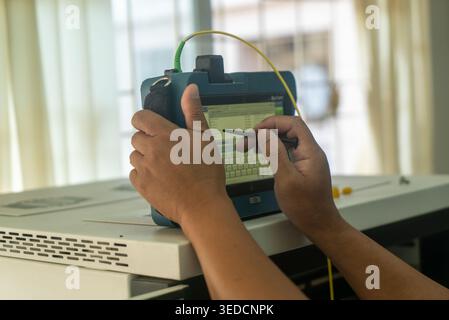 A person interacts with a digital device in an office, showcasing modern technology and productivity. The close-up highlights the hands and tablet as Stock Photo