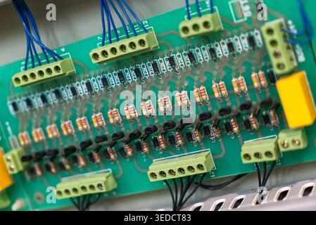 Close-up view of a circuit board showing various electronic components connected by wires, ideal for technology or engineering projects focused on ele Stock Photo