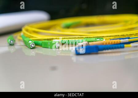Close-up view of fiber optic cables featuring vibrant yellow and green colors. Ideal for showcasing modern communication technology and networking sol Stock Photo