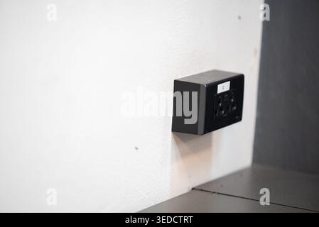 This image showcases a modern electrical outlet installed on a white wall, blending seamlessly with contemporary interior decor and highlighting minim Stock Photo