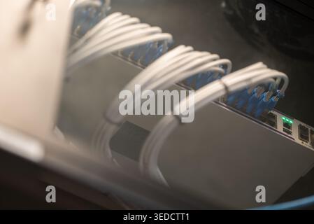 A close-up view of a network switch with several cables connected, showcasing technology and infrastructure for data transmission and network manageme Stock Photo