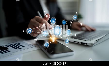 A business professional engages with a smartphone displaying digital security icons. The scene highlights the integration of technology and data Stock Photo