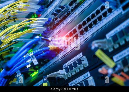 A detailed view of a network switch featuring multiple colorful cables and lights. This image captures the complexity of data communication and networ Stock Photo