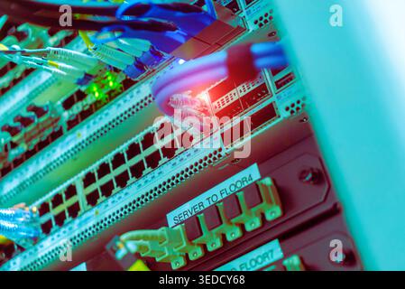 Close-up view of colorful cables and advanced network equipment inside a server rack. This vibrant setup showcases modern technology and data transmis Stock Photo
