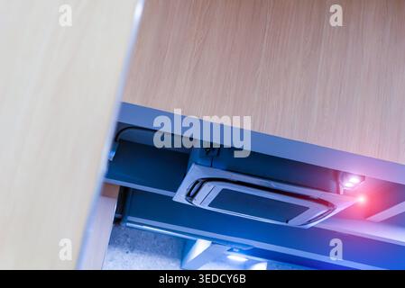 A modern office workspace featuring a sleek drawer with technology setup. This clean design showcases innovation and minimalism, enhancing productivit Stock Photo