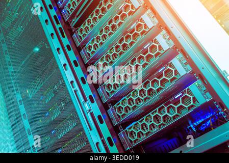A view of a modern data center rack showcasing multiple network servers with blue lighting. This image captures the essence of advanced technology and Stock Photo