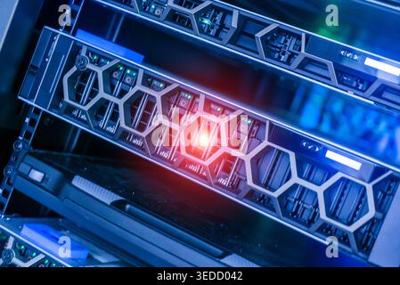 Explore a modern data center showcasing advanced server hardware with vibrant LED lights. Ideal for illustrating tech environments and innovations. Stock Photo