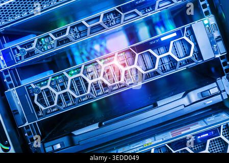 Close-up view of modern data center rack servers with colorful LED lights highlighting advanced technology in a secure and organized environment. Stock Photo