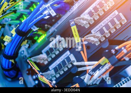 Close-up view of detailed networking cables and server connections in a modern data center, showcasing advanced technology for efficient data manageme Stock Photo