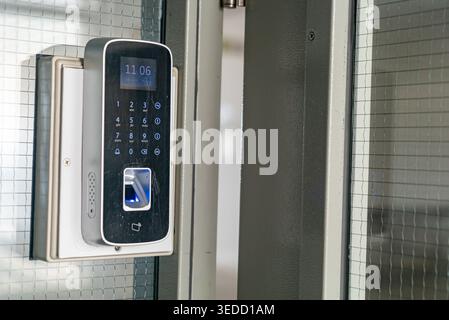 A close-up view of a modern digital door lock system featuring a keypad and fingerprint scanner. Ideal for showcasing advanced security and access con Stock Photo
