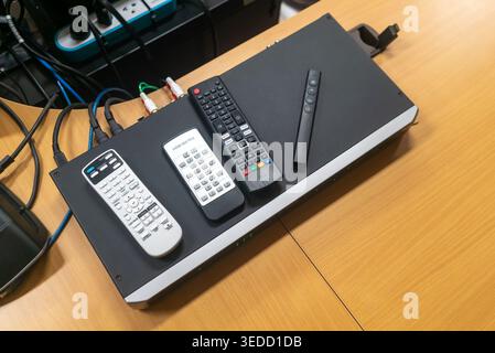 A collection of remote controls arranged neatly on a black surface, highlighting technology and organization in a modern workspace. Ideal for illustra Stock Photo