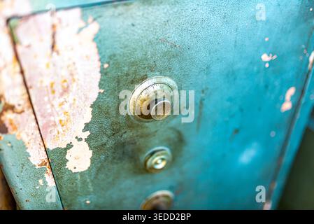 Close-up of a vintage metal safe with a rusty patina finish, showcasing its unique texture and detail. Perfect for themes of history and industrial de Stock Photo