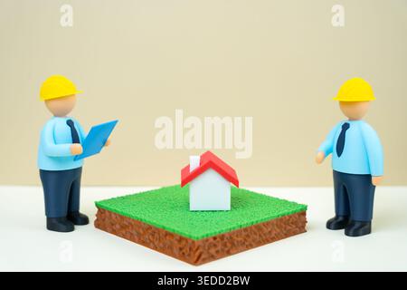 Two engineers discuss the stages of construction of a residential building. Concept of the house construction. focusing on planning, design decisions, Stock Photo