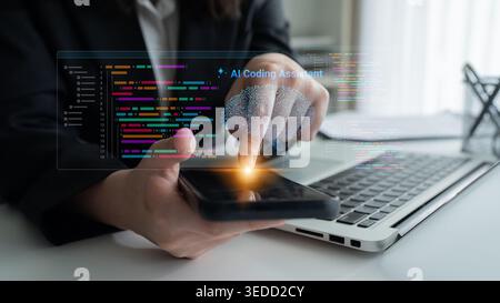 A modern workspace showcasing a programmer interacting with an AI coding assistant on a smartphone, highlighting innovation in software development Stock Photo