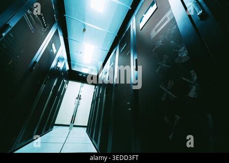 View of a modern data center showcasing server racks. This image emphasizes technology infrastructure with a focus on digital storage solutions in a p Stock Photo